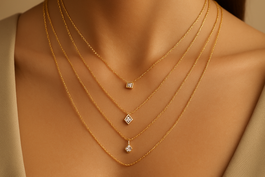 A close-up of a neckline adorned with several delicate, layered gold chains, some featuring tiny sparkling lab-grown diamond pendants, symbolizing minimalist elegance and Xazina's versatile jewellery.