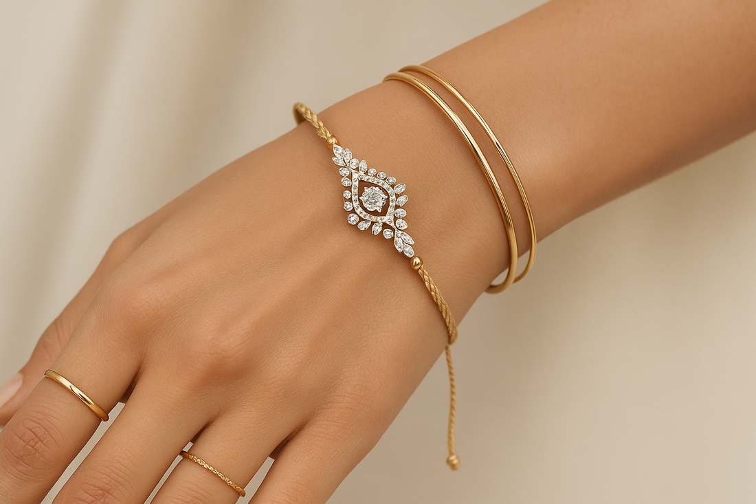 A woman's hand wearing a delicate Xazina lab-grown diamond rakhi bracelet, styled with other everyday jewellery on her wrist.